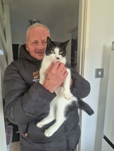 Pete from Trusted Steps holding a cat during a home visit in Corby
